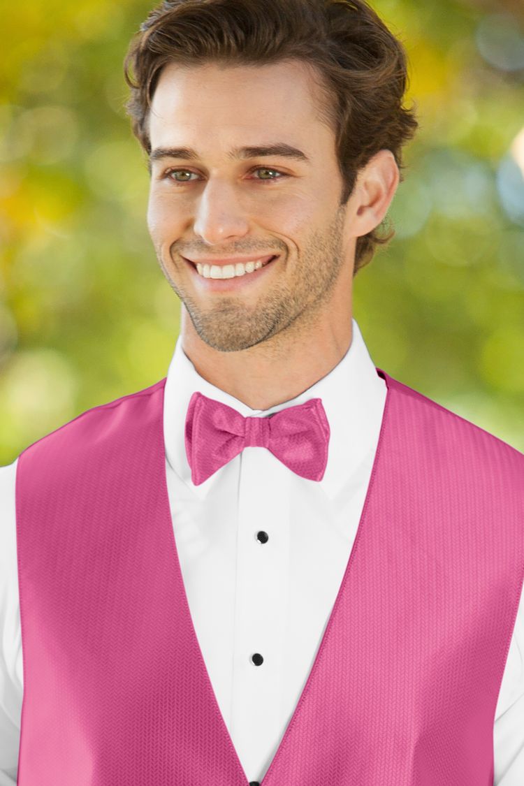 Man wearing the Herringbone Bright Fuchsia Bow Tie with a matching vest