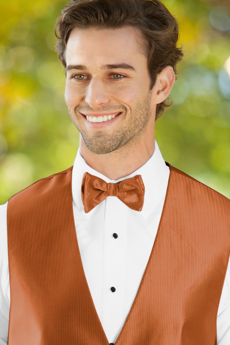 Man wearing the Herringbone Burnt Orange Bow Tie with a matching vest