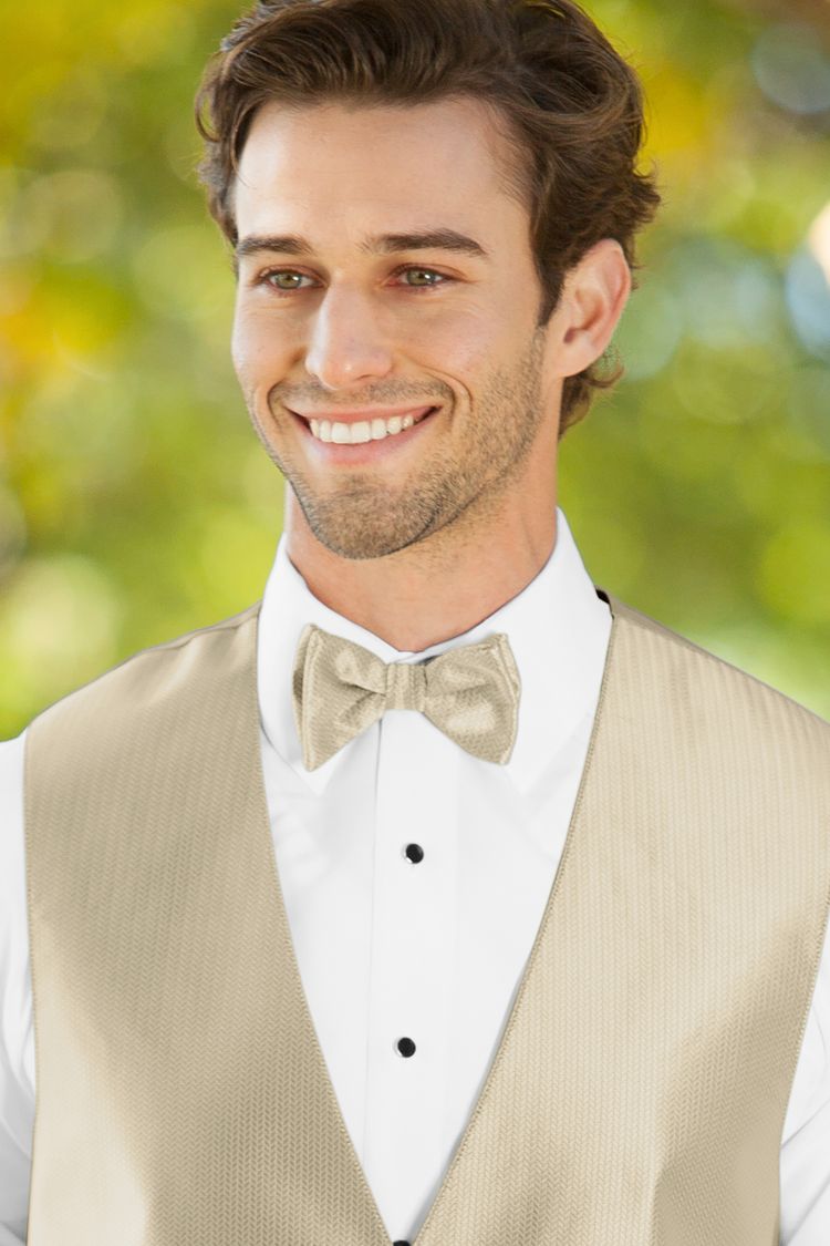 Man wearing the Herringbone Champagne Bow Tie with a matching vest