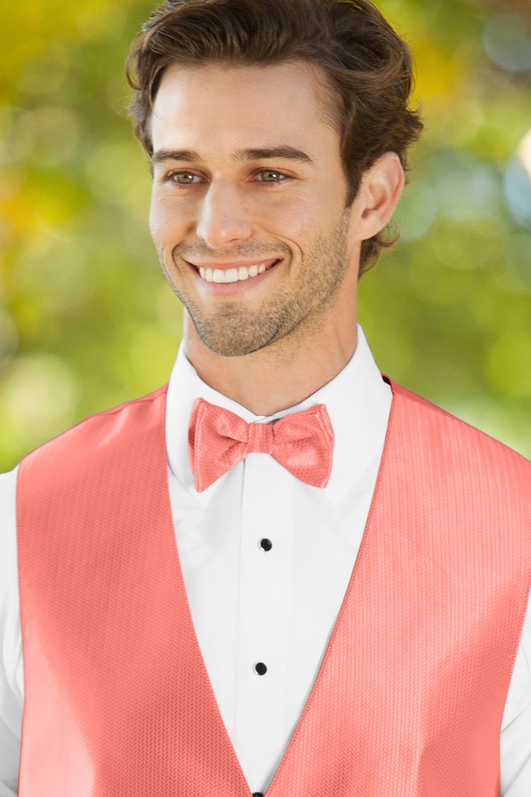 Man wearing the Herringbone Coral Bow Tie with a matching vest