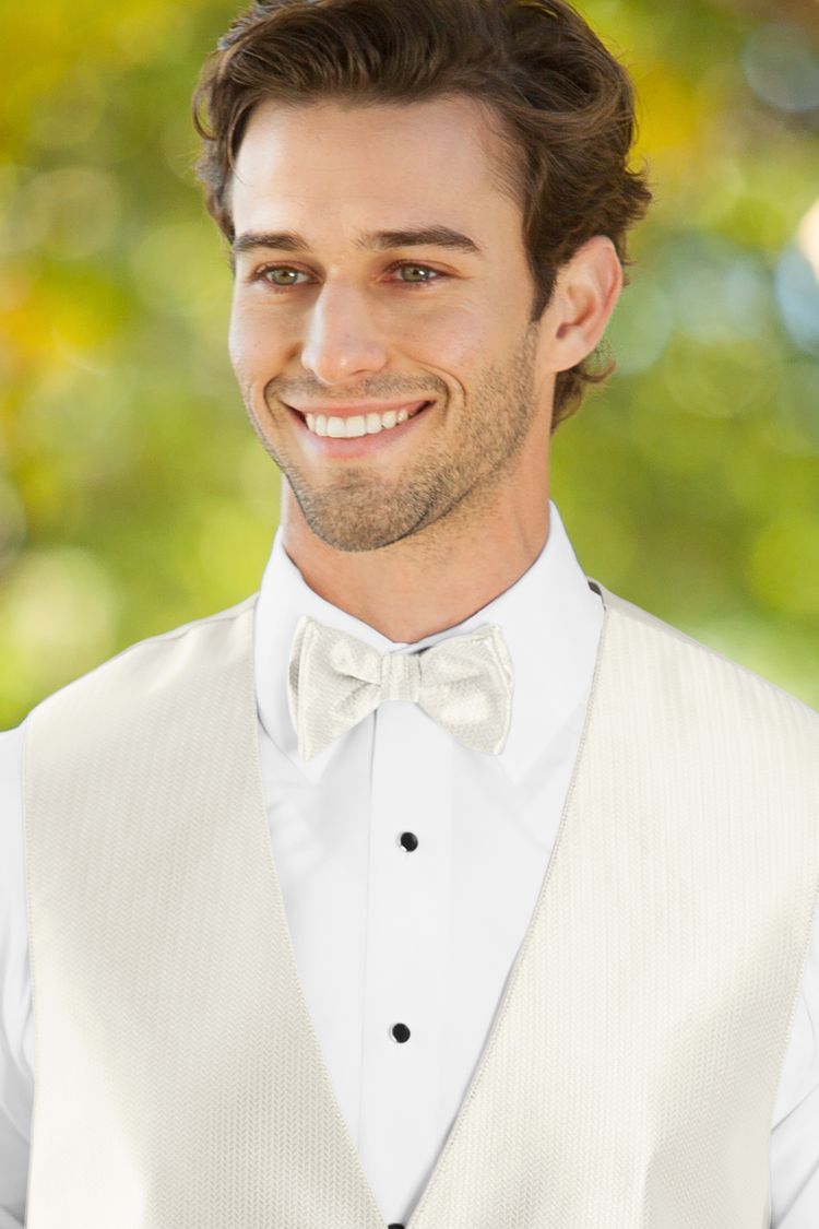 Man wearing the Herringbone Ivory Bow Tie with a matching vest