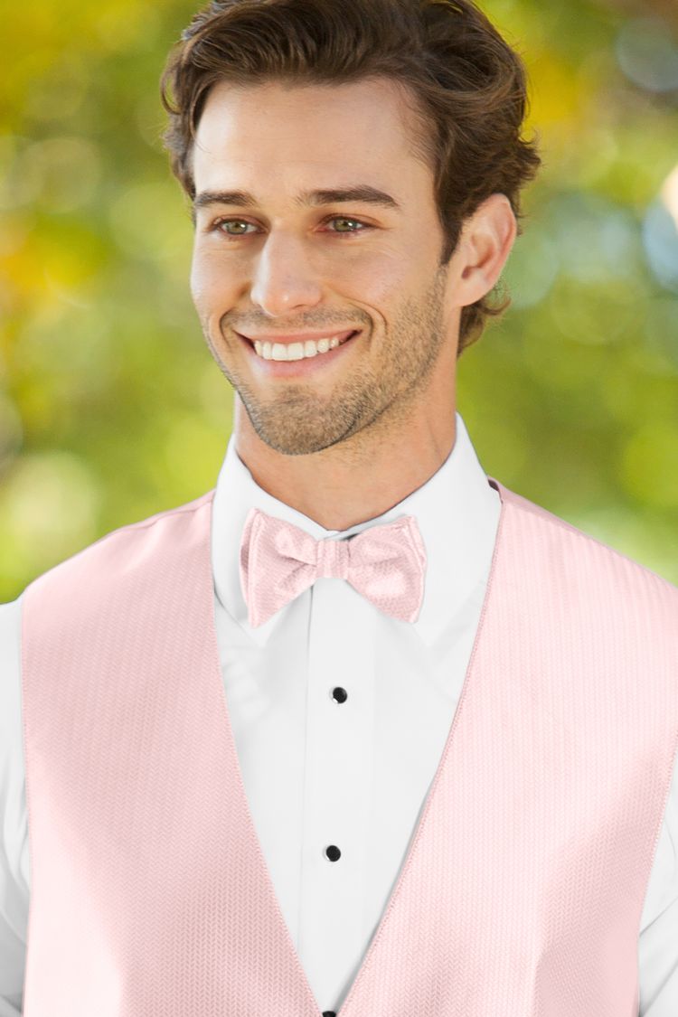 Man wearing the Herringbone Petal Pink Bow Tie with a matching vest