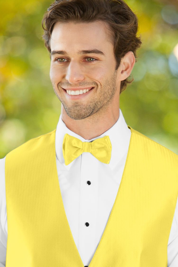 Man wearing the Herringbone Sunbeam Bow Tie with a matching vest
