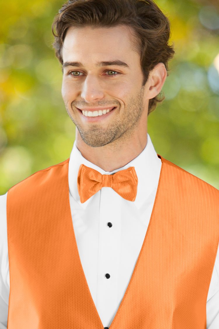 Man wearing the Herringbone Tangerine Bow Tie with a matching vest