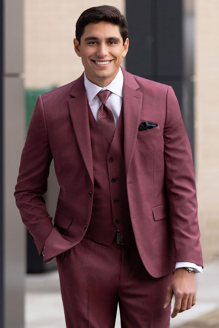 man wearing brick stretch suit with matching vest, white shirt, and rosewood striped windsor tie
