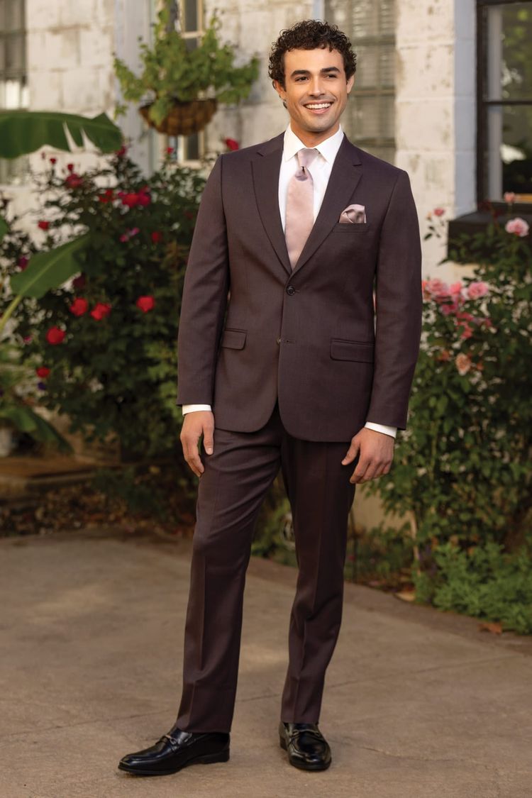 man wearing eggplant suit coat, pant, vest with white shirt and light pink windsor tie and matching pocket square