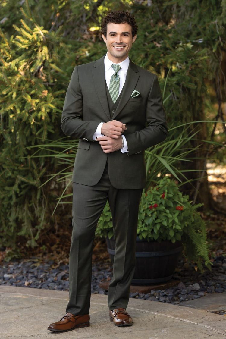 man wearing olive suit with matching vest, white shirt, and evergreen striped windsor tie and pocket square