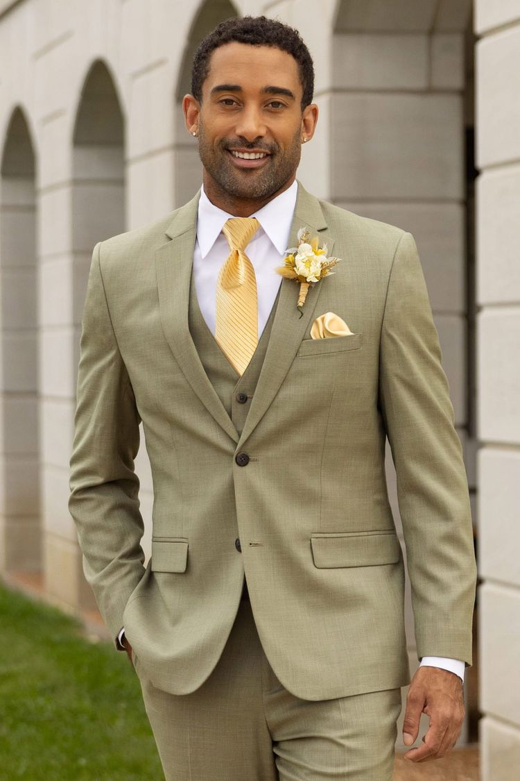 man wearing Sage Green Stretch Suit with white shirt, yellow tie, and white Synchro shoes by Stacy Adams