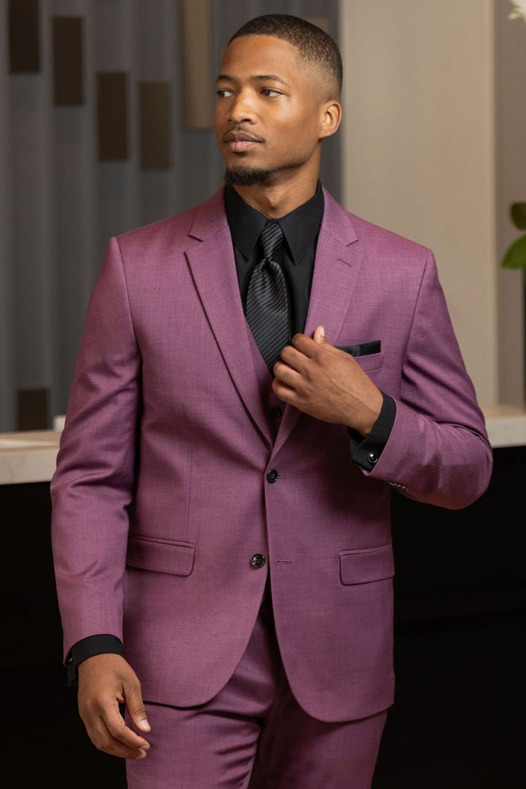 man wearing violet stretch suit with matching vest, black shirt, and black striped windsor tie