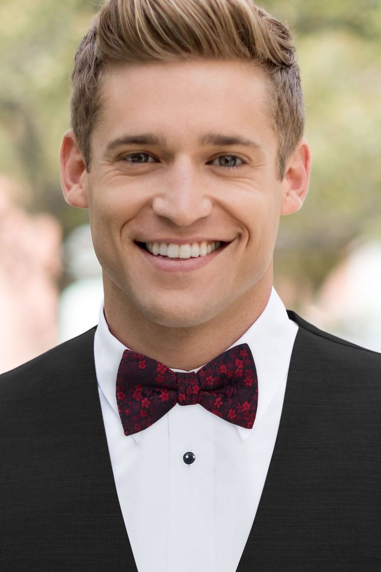 Guy wearing a Floral Apple Red Bow Tie with a black vest