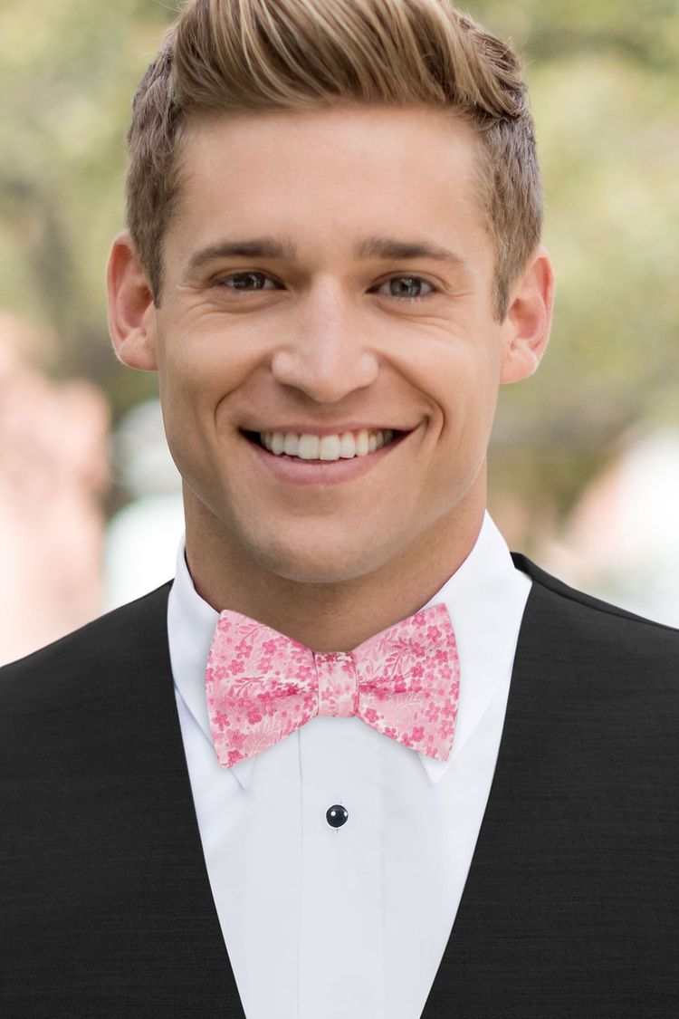 Man wearing a Floral Bubblegum Pink Bow Tie with a black vest