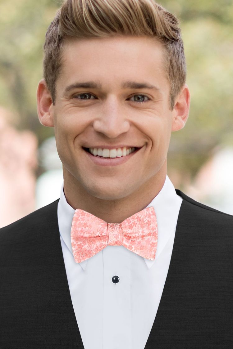 Man wearing a Floral Dark Coral Bow Tie with a black vest