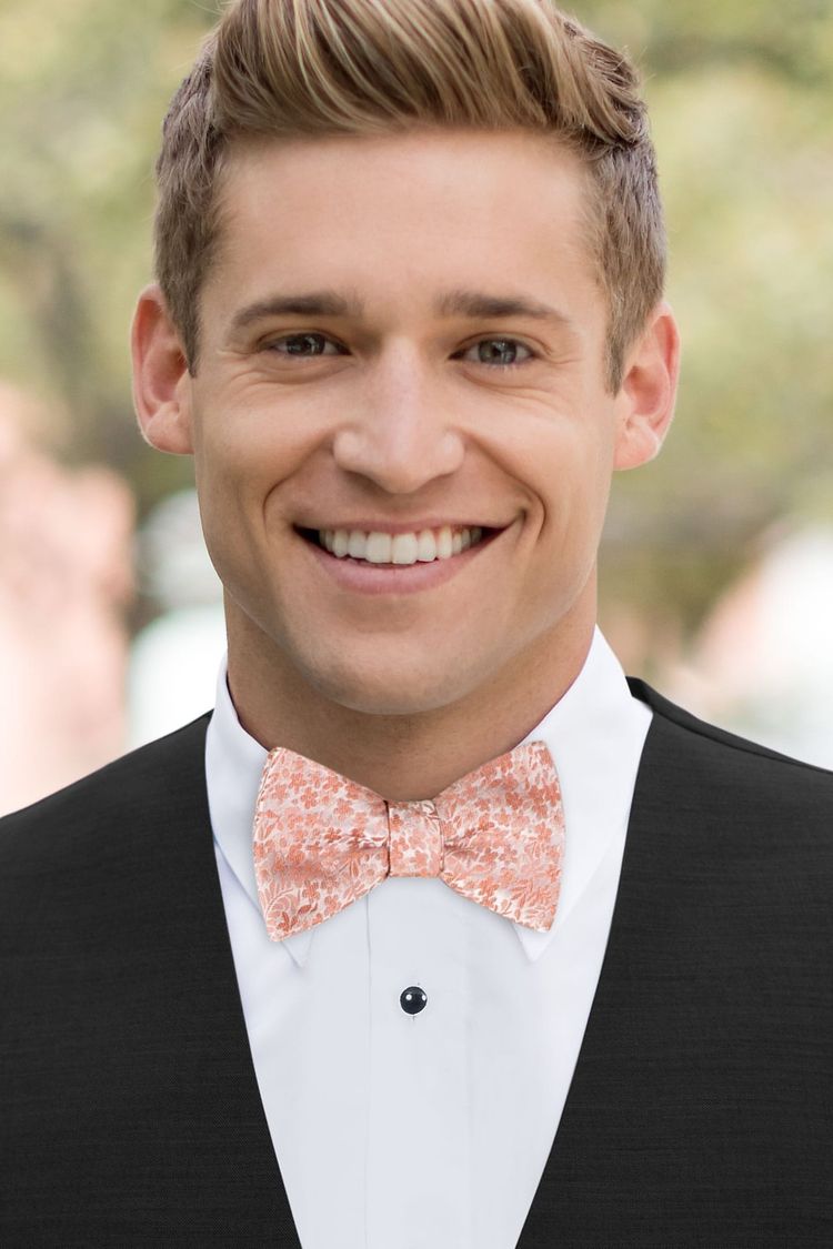 Man wearing a Floral Dusty Coral Bow Tie with a black vest