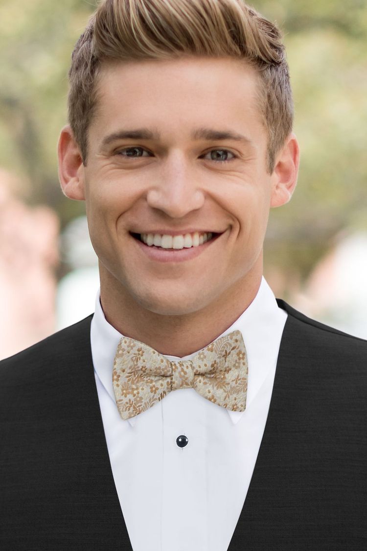 Man wearing a Floral Gold Bow Tie with a black vest