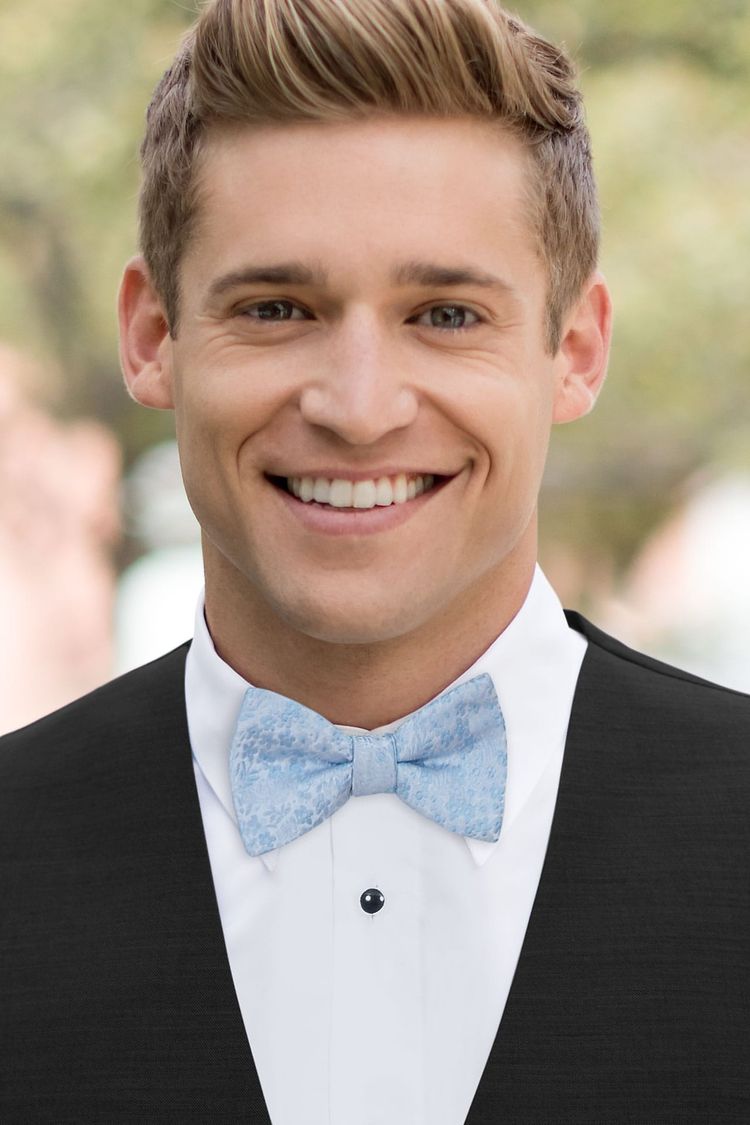 Guy wearing a Floral Lite Blue Bow Tie with a black vest