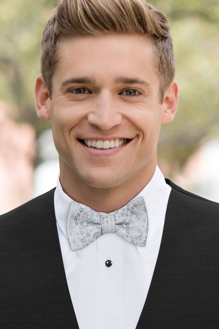 Guy wearing a Floral Platinum Bow Tie with a black vest