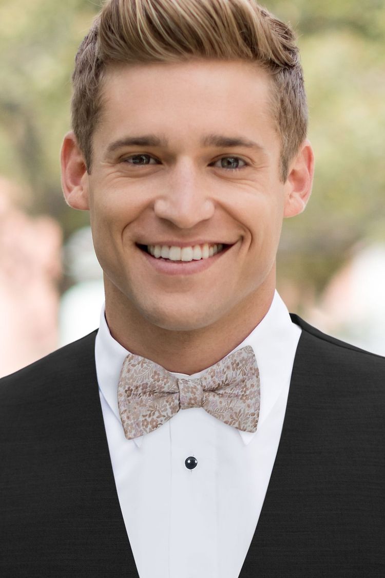 Guy wearing a Floral Rose Gold Bow Tie with a black vest