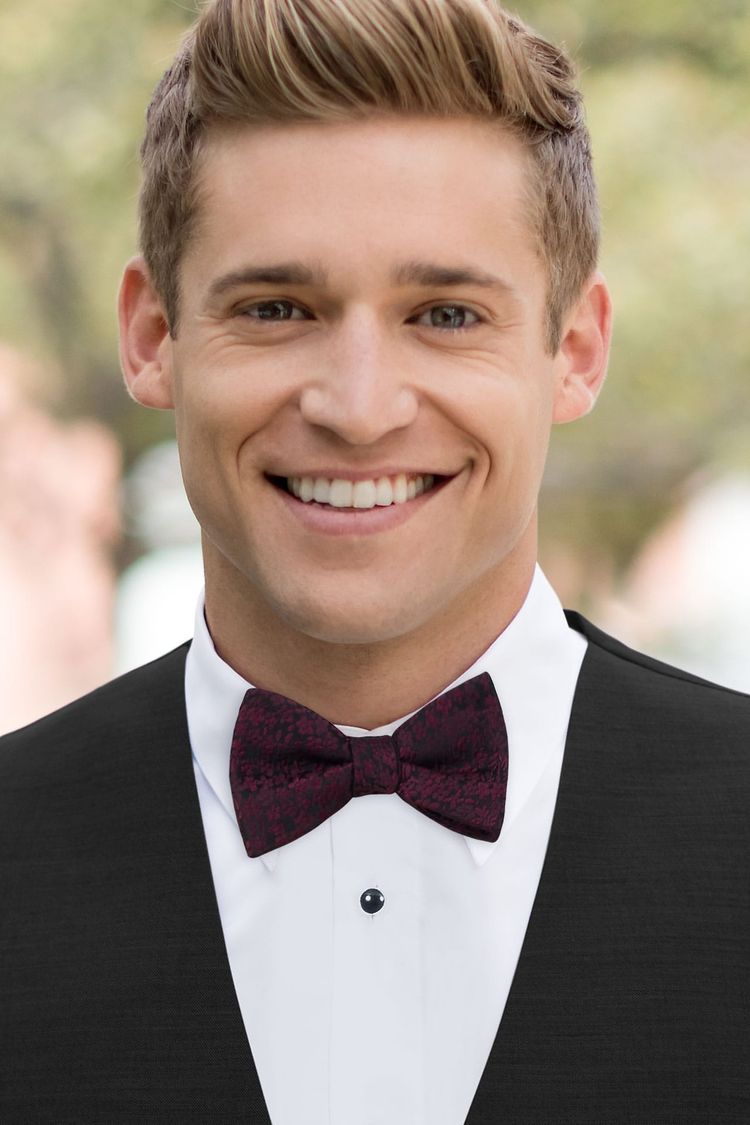 Man wearing a Floral Win Bow Tie with a black vest