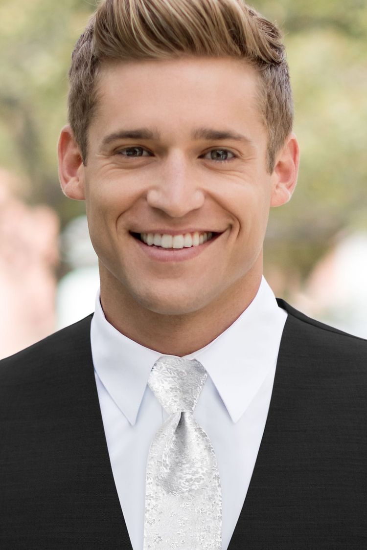 Man wearing a Floral Silver Metallic Windsor Tie with a black vest