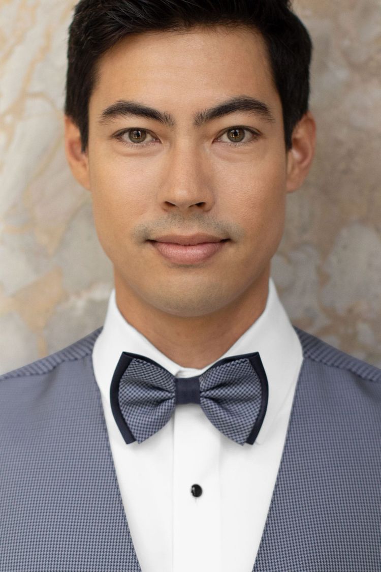 Man wearing a foundation bow tie navy with a matching vest