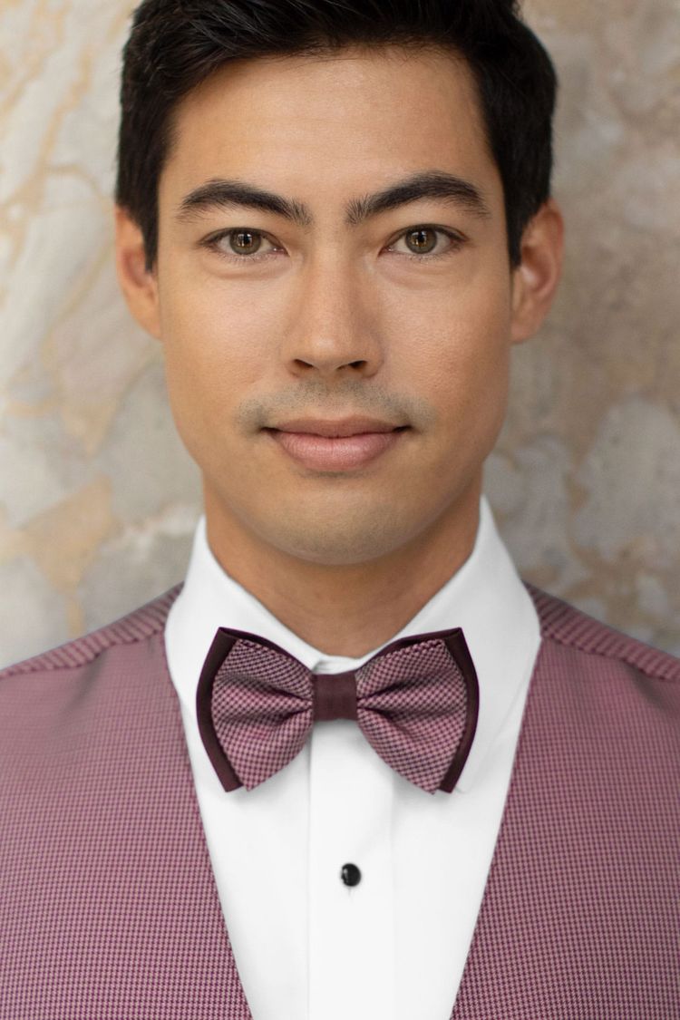 Man wearing a foundation bow tie wine with a matching vest