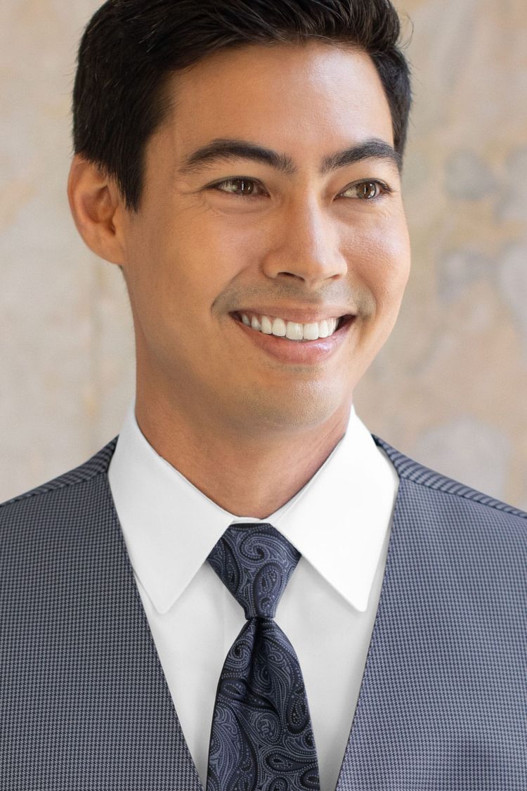 Man wearing a Foundation Paisley Navy Windsor Tie with a matching vest