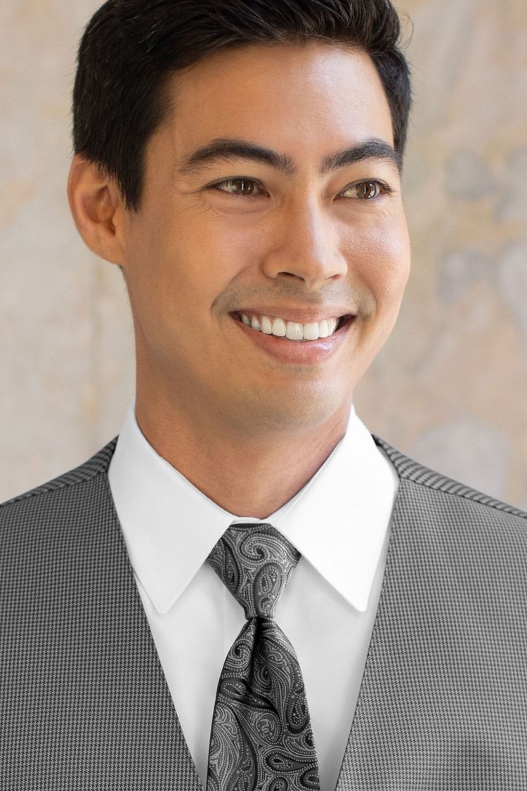 Man wearing a Foundation Paisley Steel Grey Windsor Tie with a matching vest