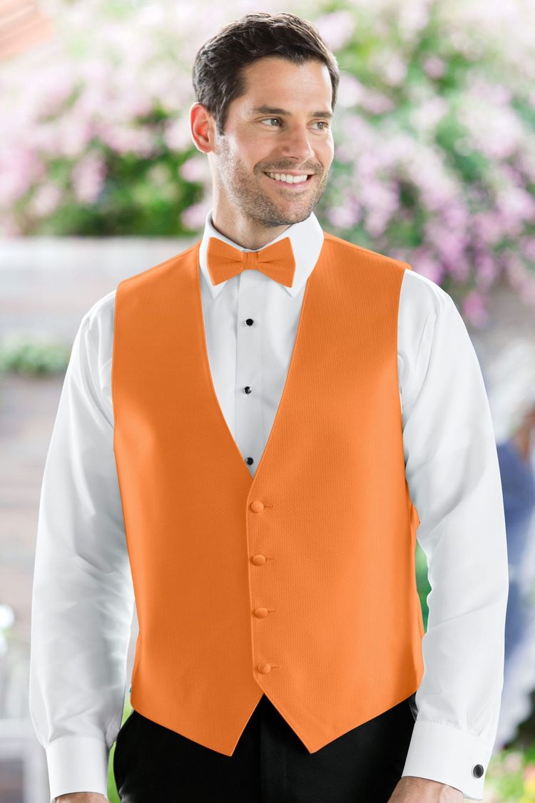 Man wearing the Herringbone Tangerine Fullback Vest with a matching tie