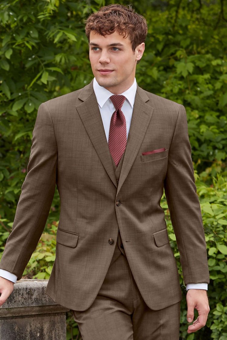 man wearing Brown Archer Suit with white shirt, wine colored windsor tie, and brown shoes
