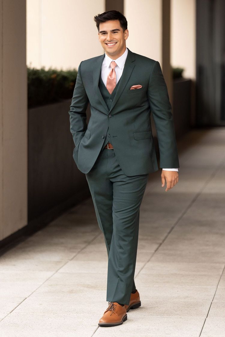 man wearing Hunter Green Luka suit coat, pant, and vest with coral windsor tie