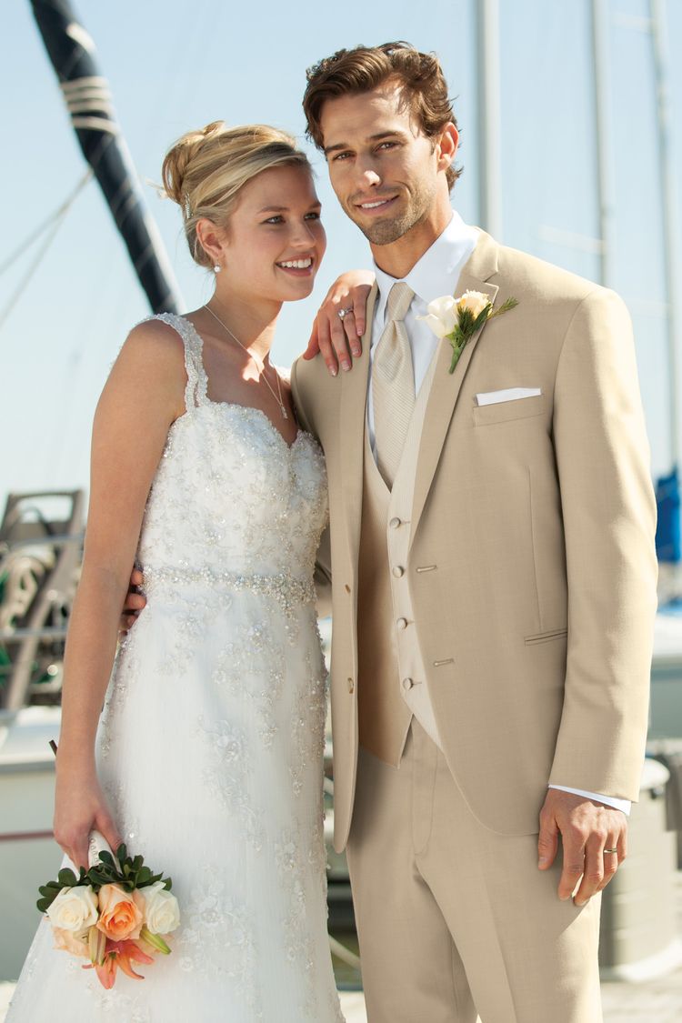 Bride and groom in the Tan Havana Wedding Suit standing on a boat
