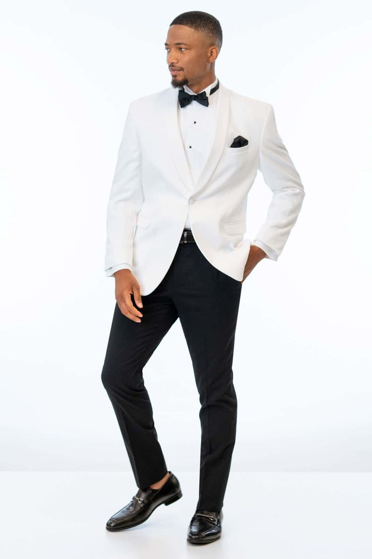 man on white background wearing the classic white dinner jacket for purchase with black pants, black loafers, and a black bow tie