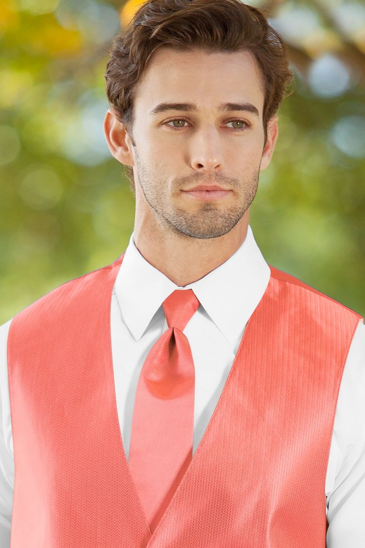 Man wearing the Herringbone Coral Windsor Tie with a matching vest