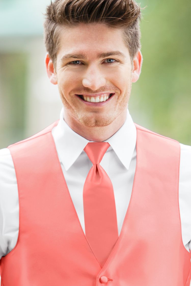 Man wearing the Expressions Coral Windsor Tie with a matching vest