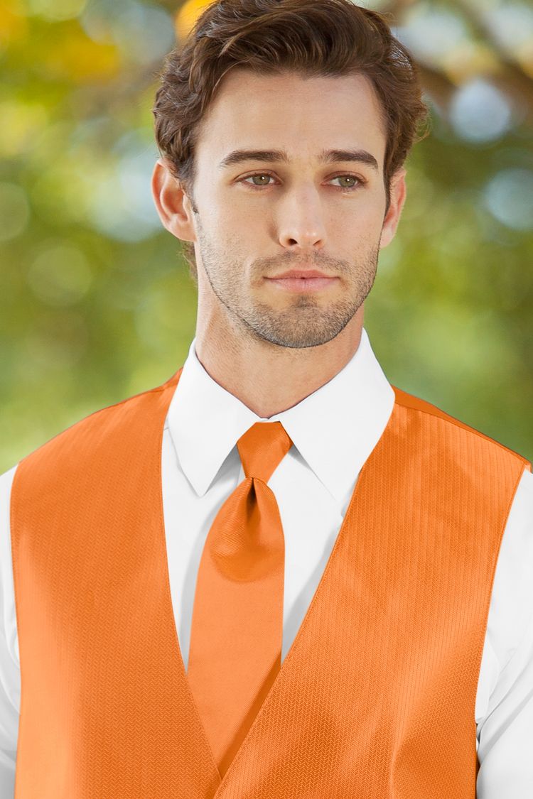 Man wearing the Herringbone Tangerine Windsor Tie with a matching vest